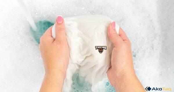 Bleach a white shirt with a logo in hand washing